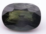 a close up view of a green tourmaline stone on a white surface