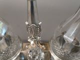 two salt and pepper shakers sitting on a silver plate