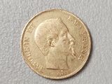 a close up of a gold coin with a man ' s face on it
