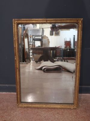 a mirror that is sitting on the floor in a room