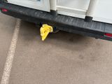 a white truck with a yellow bag on the back of it