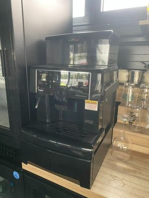 a black coffee machine sitting on a counter in a kitchen