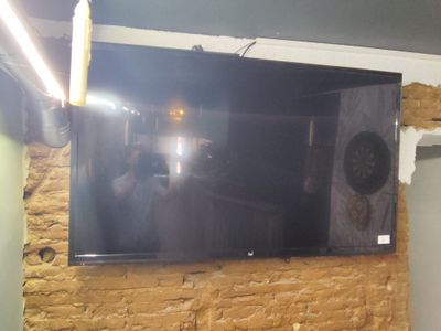 a large flat screen tv mounted on a brick wall
