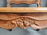 a wooden bench with a wicker back and a wicker seat