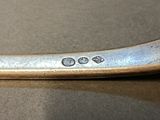 a silver spoon that is sitting on a table