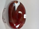 a glass vase with a red and white design on it
