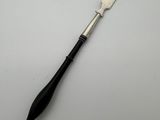 a fork with a black handle sitting on top of a white table