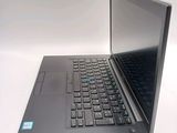 a laptop computer sitting on a table with a keyboard