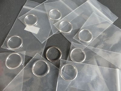 a lot of clear plastic bags with silver rings on them