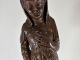 wooden statue of a woman holding a baby in her arms