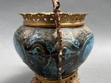 a blue and gold vase with a crown on top of it