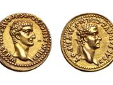 a gold coin with a bust of a man and a bust of a woman