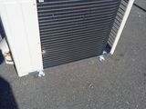 a white air conditioner sitting on top of a parking lot