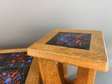 two wooden tables with blue and orange designs on them