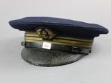 navy officer ' s hat with insignia on it on a white surface
