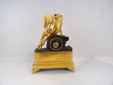 a gold statue of an angel on top of a clock