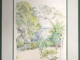 framed watercolor painting of a view of a lake and trees