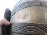 a close up of a person ' s hand holding a metal helmet