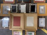 a lot of framed pictures on the wall in this room