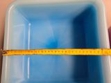 a measuring tape in the bottom of a blue bowl