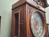 a large wooden grandfather clock on display in a room