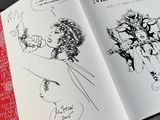 an open book with a drawing of a man and a woman on it