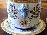 a cup and saucer sitting on a wooden table