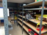 many shelves that have various items on them in the room