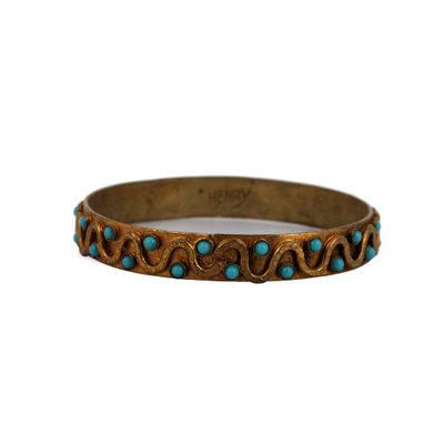 a close up of a bracelet on a white background