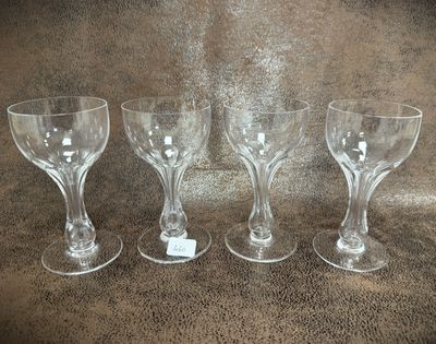 three wine glasses sitting on a table next to each other