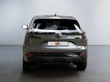 the rear end of a grey suv parked in a room