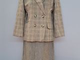 an image of a woman ' s suit on a mannequin stand