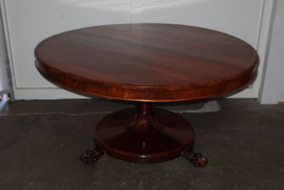 a round table with a wooden top in a room
