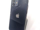 a broken iphone sitting on top of a stand
