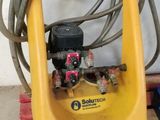 the hose is attached to a yellow machine on a pallet