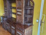 an image of a wooden china cabinet in a yellow room