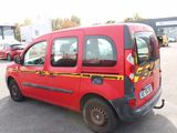 a red van that is parked in a parking lot