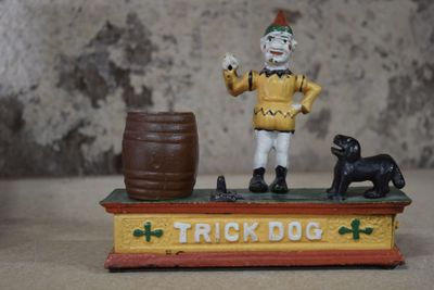 toy figurine of a clown with a dog and barrel of beer