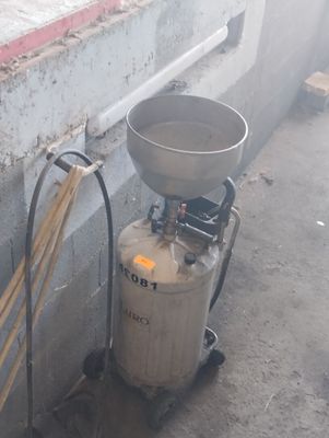 a tank with a metal tank and a broom next to it