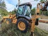 a tractor that is sitting in the grass by the road