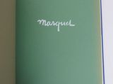 an open book with the word macqueel written in white on it
