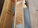 a person that is opening a drawer in a room