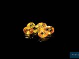 a pair of yellow sapphires sitting on top of a black surface