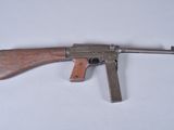 an old gun with a wooden handle on a white surface