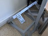 a metal stand that has a remote control on it