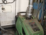 a green machine that is sitting in a room
