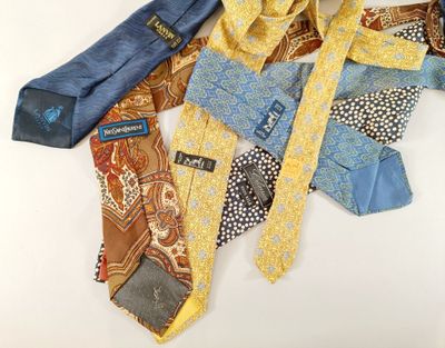 several different colored ties laid out on a white surface