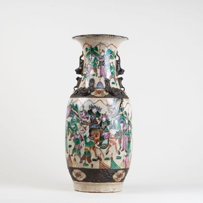 a vase with a floral design on it sitting on a table