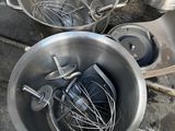 a metal bowl with a whisk inside of it