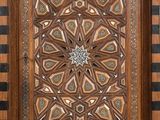 an ornate wooden door with a geometric design on it